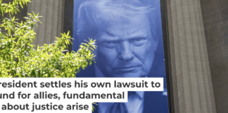 A banner featuring President Trump on the outside of the DOJ building in Washington, D.C. Andrew Harnik/Getty Images